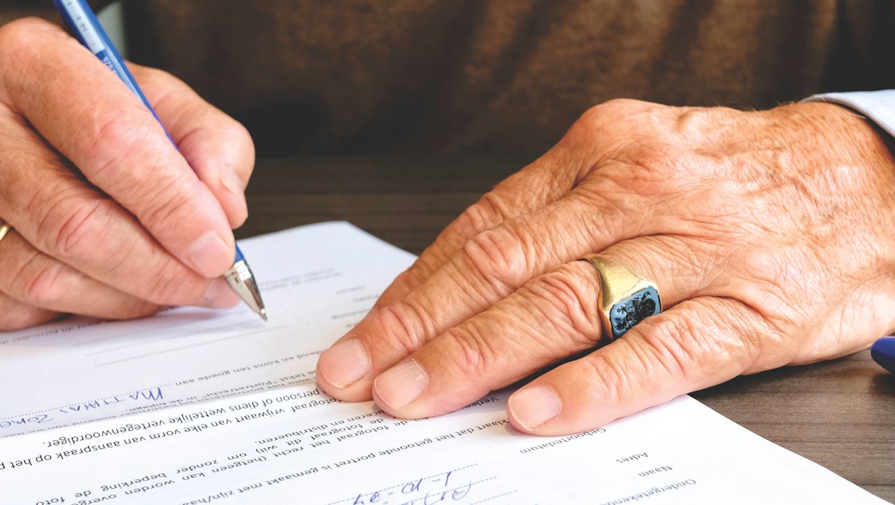 person isgning papers