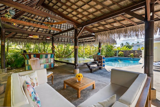 backyard-with-pool-and-seating-area-surrounded-by-greenery